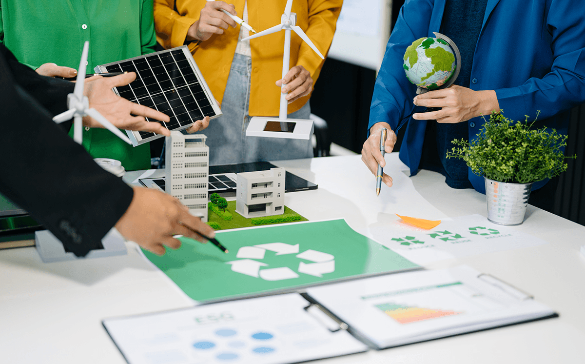 Image of people around desk discussing sustainability